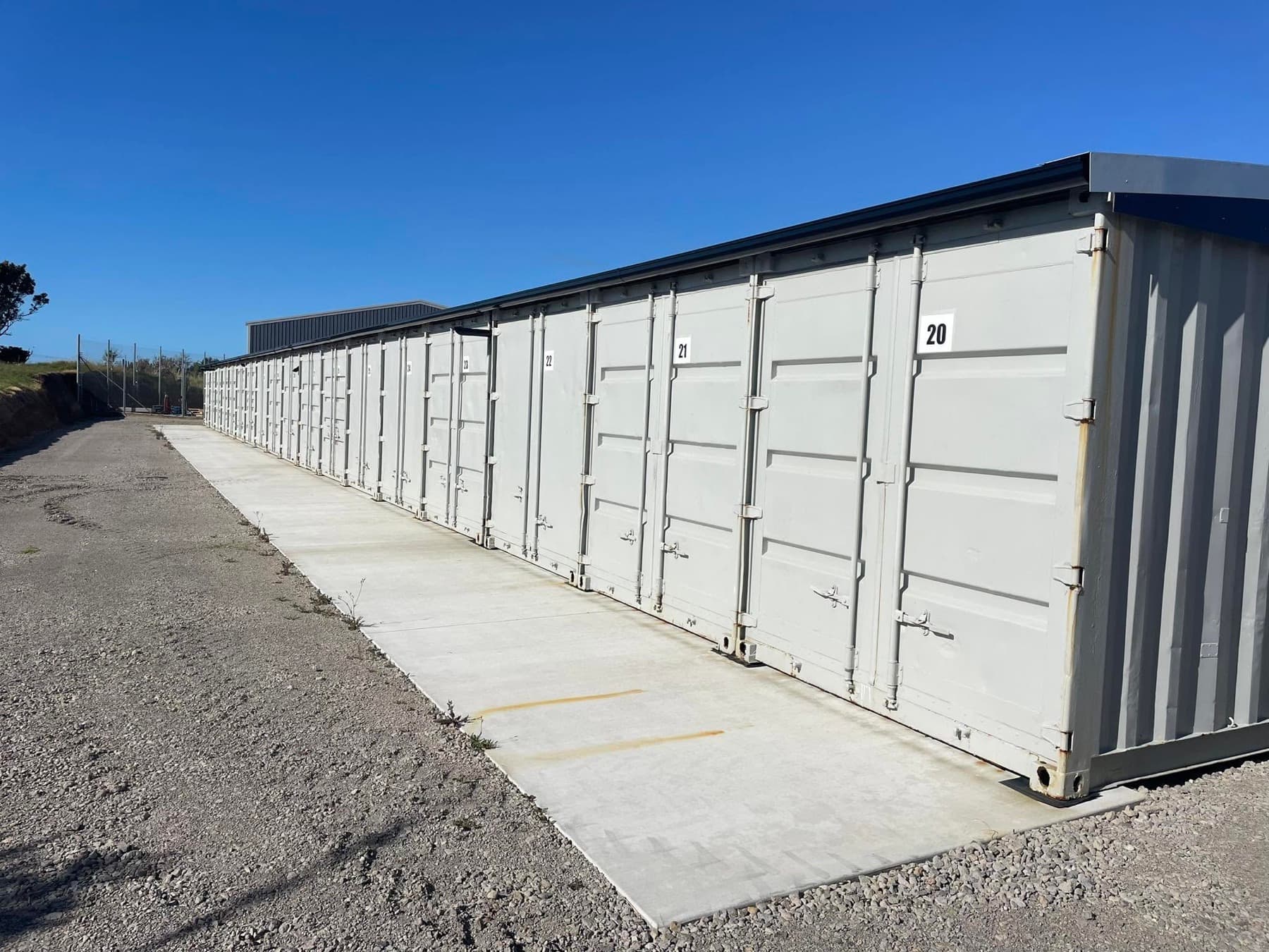 Row of 20ft storage containers under a roof in New Plymouth